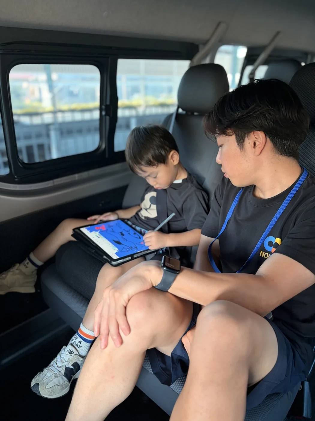 送迎車内でコーチが子どもの様子を見守る様子
